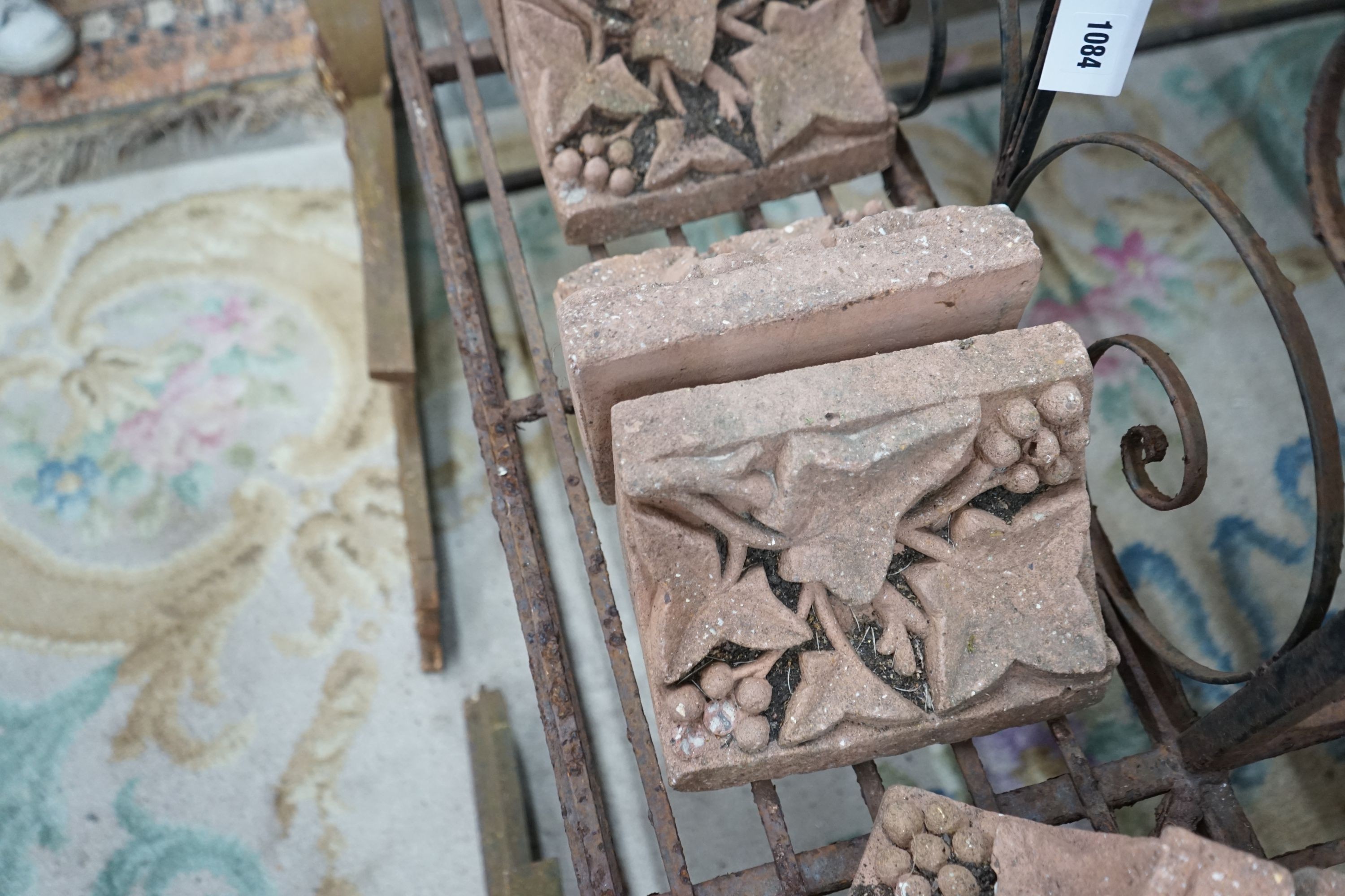 Fourteen terracotta edging tiles moulded with fruiting vines, each width 23cm, depth 14cm, height 15cm